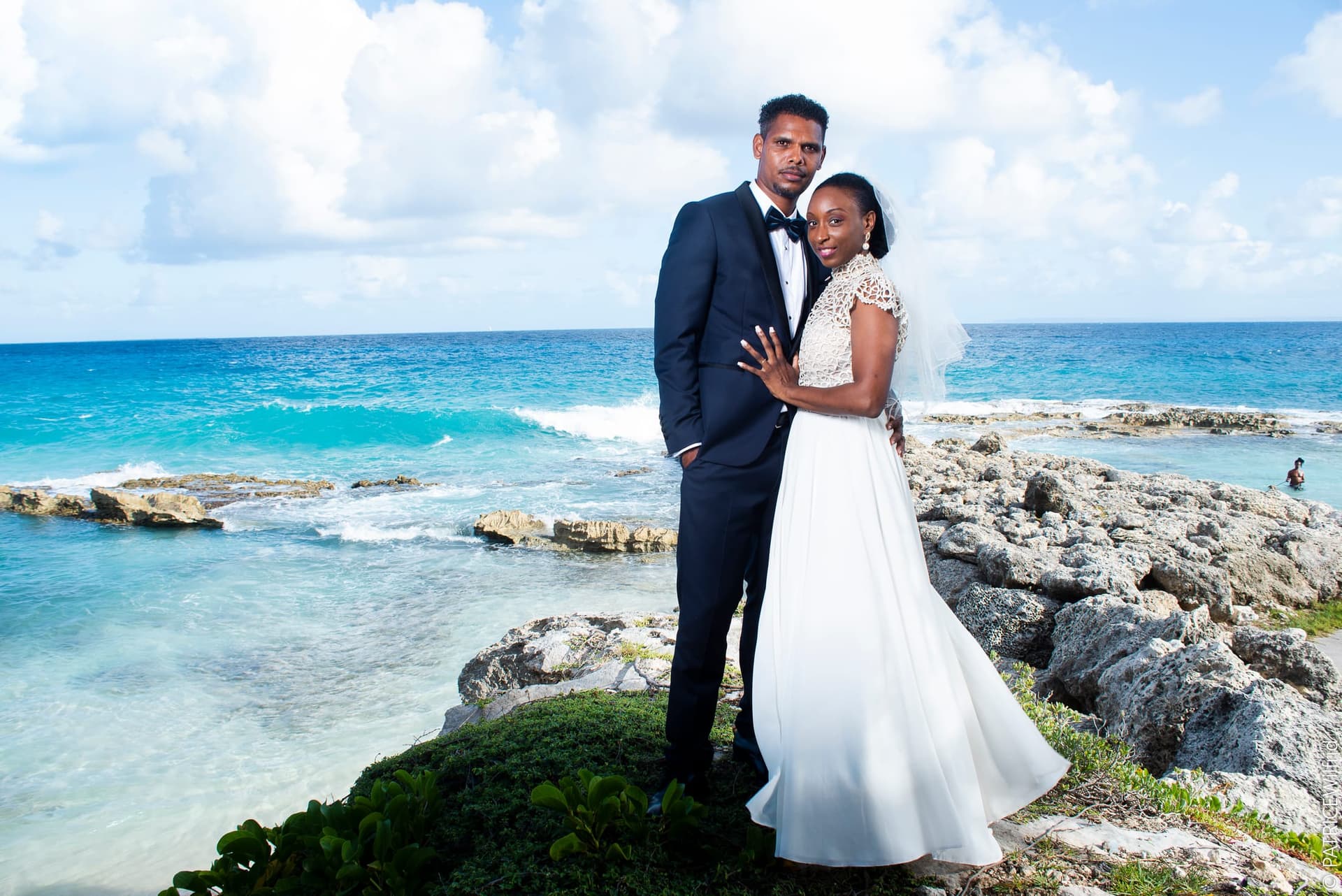 Un couple de mariés face à l’océan